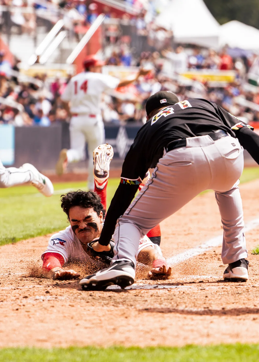 Vancouver Canadians runner sliding under a tag against the Eugene Emeralds at Nat Bailey Stadium